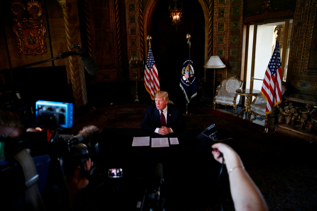 President Donald Trump takes questions from the media after speaking via teleconference with troops from Mar-a-Lago estate...