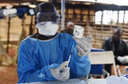A Congolese health worker prepares to administer Ebola vaccine, outside the house of a victim who died from Ebola in the village of Mangina in North Kivu province of the Democratic Republic of Congo, August 18, 2018. REUTERS/Olivia Acland/File Photo