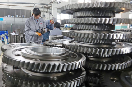 Workers inspect engine gears at a company under Dongbei Special Steel Group in China. The country's manufacturing industry has taken a hit since the tariffs went into effect. Photo Courtesy: Reuters