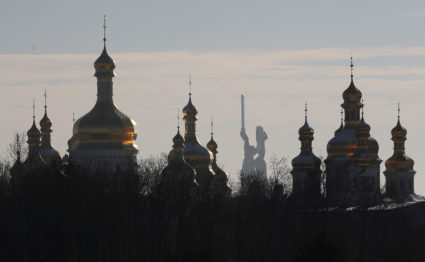 Domes of the Dormition Cathedral of the Kiev Pechersk Lavra monastery are seen in front of the Mother Homeland monument in Kiev, Ukraine November 30, 2018. REUTERS/Valentyn Ogirenko