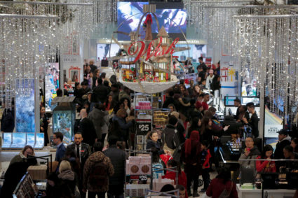 People shop in Macy's Herald Square during early opening for the Black Friday sales in Manhattan last year. Americans are expected to spend more this year because of the improved economy. Photo by Andrew Kelly/Reuters