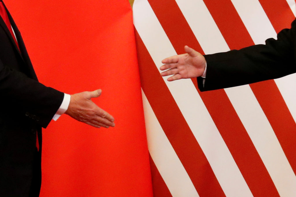 U.S. President Donald Trump and China's President Xi Jinping shake hands after making joint statements at the Great Hall o...