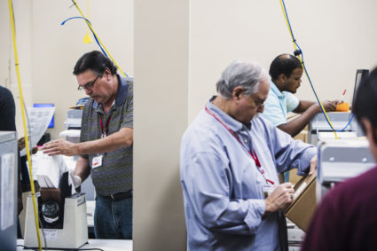 Voting technicians work in the ballot room at the Broward County Supervisor of Elections office in Lauderhill, FL on Wednesday, November 14, 2018. Photo by Scott McIntyre for PBS New Hour
