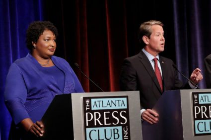 Republican gubernatorial candidate for Georgia Brian Kemp speaks as Democratic candidate Stacey Abrams looks on during a debate in Atlanta, Georgia, U.S, October 23, 2018. Photo by John Bazemore/Pool via REUTERS