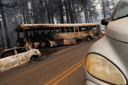 An abandoned and burned school bus is seen on Skyway during the Camp Fire in Paradise, California, U.S. November 9, 2018. Photo by REUTERS/Stephen Lam