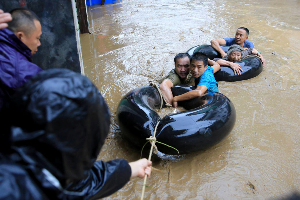 Rescuers evacuate people in a flooded area in Rongshui Miao Autonomous County in Liuzhou, Guangxi Zhuang Autonomous Region...