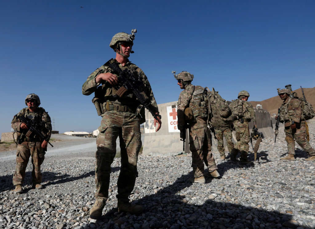 U.S. troops wait for their helicopter flight at an Afghan National Army (ANA) base in Logar province, Afghanistan. Photo b...