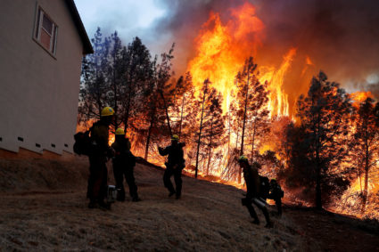 A group of U.S. Forest Service firefighters monitor a back fire while battling to save homes at the Camp Fire in Paradise, California on November 8, 2018. Photo by Stephen Lam/Reuters