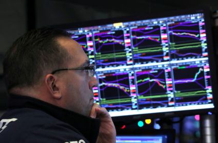 A trader looks at price monitors as he works on the floor at the New York Stock Exchange (NYSE) in New York City, New York, U.S., December 4, 2018. Photo by Brendan McDermid/Reuters/File Photo