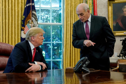 President Donald Trump speaks to White House Chief of Staff John Kelly after an event with reporters in the Oval Office at the White House in Washington, D.C. Photo by Jonathan Ernst/Reuters