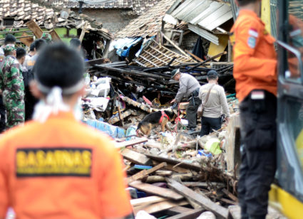 Indonesian policemen search for victims among debris after a tsunami hit at Kalianda in South Lampung, Indonesia. Photo by Antara Foto/Ardiansyah via Reuters