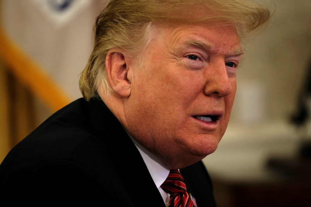 President Donald Trump speaks with reporters after holding a video call with U.S. military service members in the Oval Off...