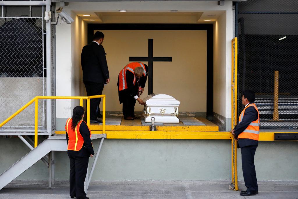 Staff of a funeral home receive the coffin containing the body of Jakelin Caal before her funeral, at La Aurora Internatio...