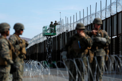 U.S. Marines deploy concertina wire at the U.S. Mexico border in preparation for the arrival of a caravan of migrants at the San Ysidro border crossing in San Diego, California. Photo by Mike Blake/Reuters