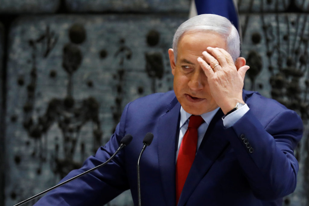 Israeli Prime Minister Benjamin Netanyahu gestures as he speaks during a ceremony whereby Amir Yaron is sworn in as Bank o...