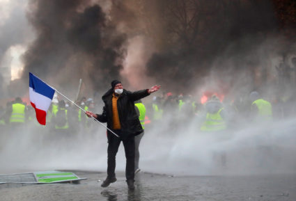 Protesters wearing yellow vests, a symbol of a French drivers' protest against higher fuel prices, are seen during riots on the Champs-Elysees in Paris, France, November 24, 2018. Photo by Gonzalo Fuentes/Reuters