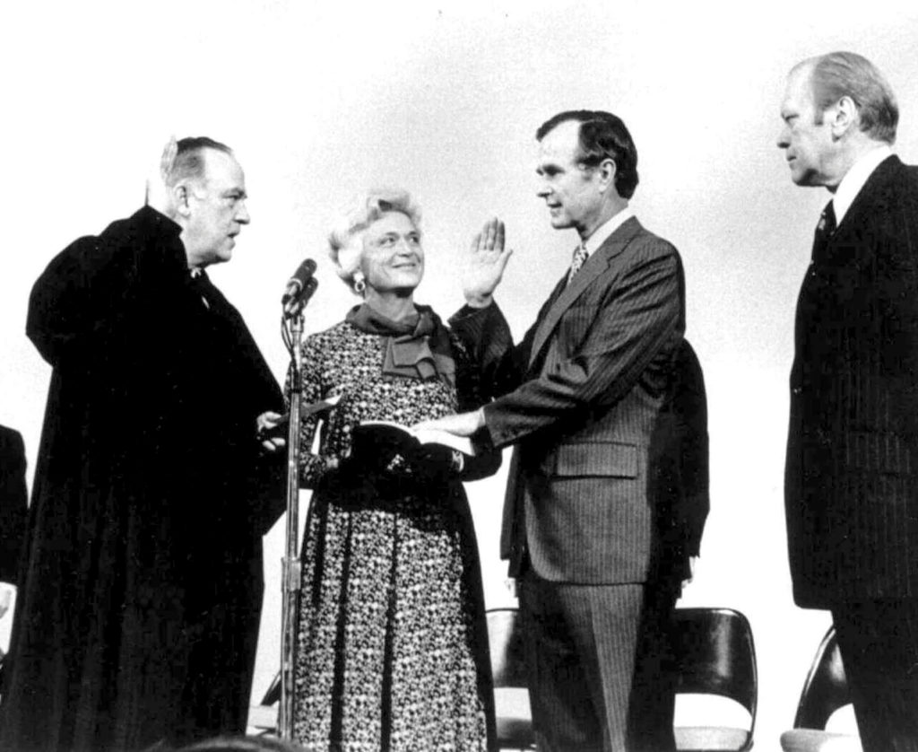 George H. W. Bush is sworn in as Director of CIA by Justice Potter Stewart (L) as President Gerald Ford (R) looks on, in t...