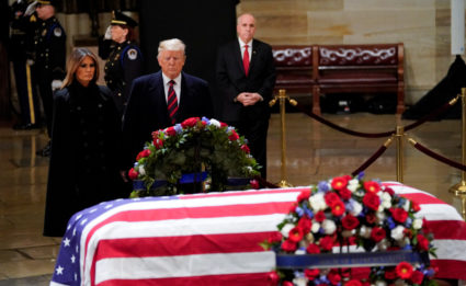 President Donald Trump and first lady Melania Trump pay their respects to former President George H. W. Bush lying in state in the U.S. Capitol Rotunda Monday. Photo by Pablo Martinez Monsivais via Reuters