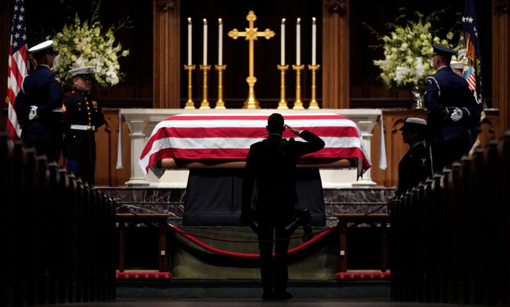 People pay their respects as the flag-draped casket of former President George H.W. Bush lies in repose at St. Martin's Ep...