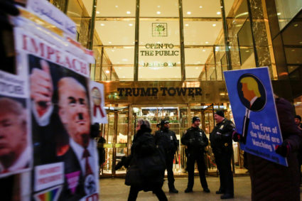New York Police Department (NYPD) officers stand guard outside Trump Tower as people participate in a protest, in New York City, U.S., February 8, 2018. Photo by Eduardo Munoz/Reuters