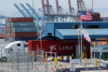 Trucks offload containers from ship at the port of Los Angeles. Photo by Mike Blake/Reuters