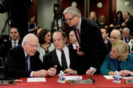U.S. Senator Patrick Leahy (D-VT) checks a text next to felllow Senators Richard Shelby (R-AL), John Hoeven (R-ND) and Shelley Moore Caputo (R-WV) as House-Senate conferees meet on border security to discuss Homeland Security funding legislation on Capitol Hill in Washington, U.S., January 30, 2019. REUTERS/Yuri Gripas