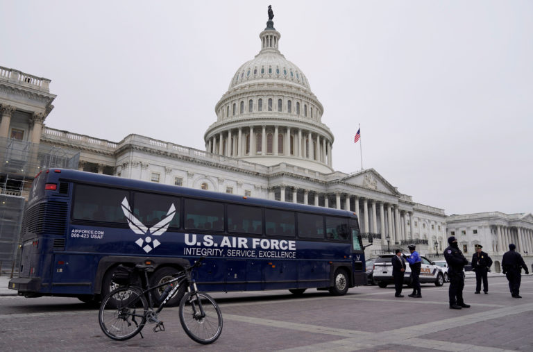 A U.S. Air Force bus meant to transport U.S. Speaker of the House Nancy Pelosi and other members of a congressional delegation to a flight to Belgium and Afghanistan sits guarded by U.S. Capitol Police in front of the Capitol after President Donald Trump cancelled the Air Force flight as the president's dispute with congressional Democrats over the partial government shutdown continues in Washington, U.S., January 17, 2019. REUTERS/Joshua Roberts