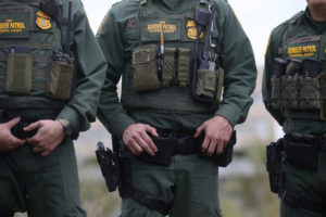 U.S. Customs and Border Patrol agents watch as President Donald Trump visits the banks of the Rio Grande River during the president's visit to the U.S. - Mexico border in Mission, Texas, U.S., January 10, 2019. Photo by REUTERS/Leah Millis
