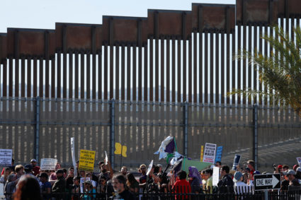 Protesters supporting the migrant caravan in Tijuana, Mexico show their solidarity in support during a march next to the border wall with Mexico in the San Ysidro neighborhood of San Diego, California, U.S. November 25, 2018. REUTERS/Mike Blake - RC123CB63260