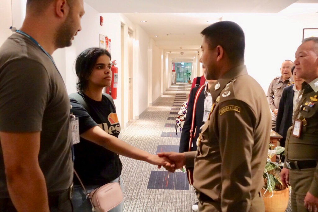 Saudi teen Rahaf Mohammed al-Qunun is greeted by Thai immigration authorities at a hotel inside Suvarnabhumi Airport in Ba...