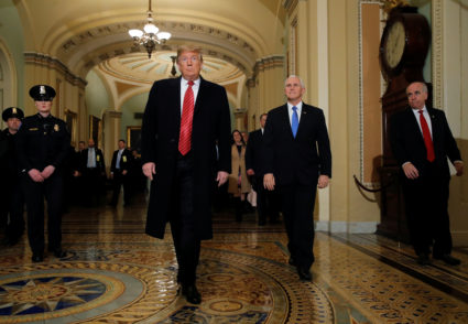 President Donald Trump is accompanied by Vice President Mike Pence as they arrive to attend a closed Senate Republican policy lunch. Trump and Democratic lawmakers have not been able to overcome their differences, pushing the government shutdown into its 20th day. Photo by Jim Young/Reuters
