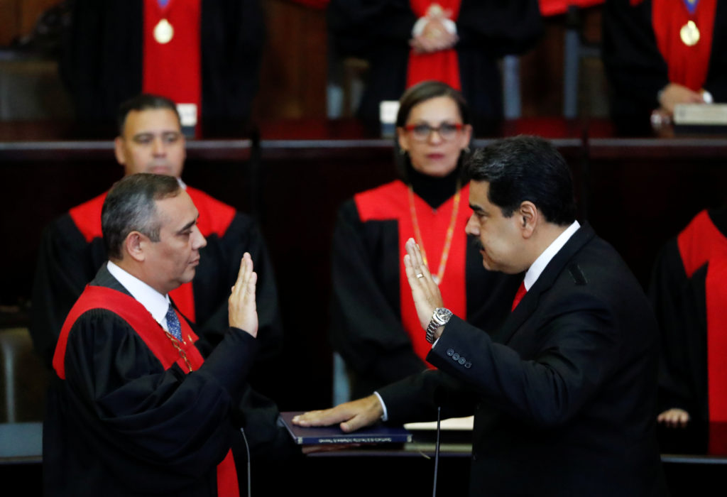 Venezuela's President Nicolas Maduro is sworn in by Venezuela's Supreme Court President Maikel Moreno, during the ceremoni...