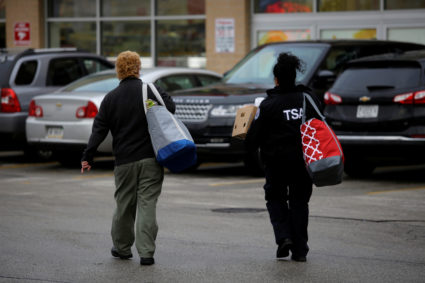 A TSA worker walks to her vehicle after receiving food from the Lakeview Pantry in Chicago on January 14, 2019. Joshua Lott/Reuters