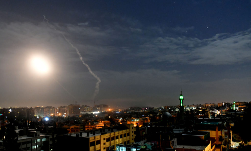 This photo, released by the Syrian official news agency SANA, shows missiles flying into the sky near international airpor...