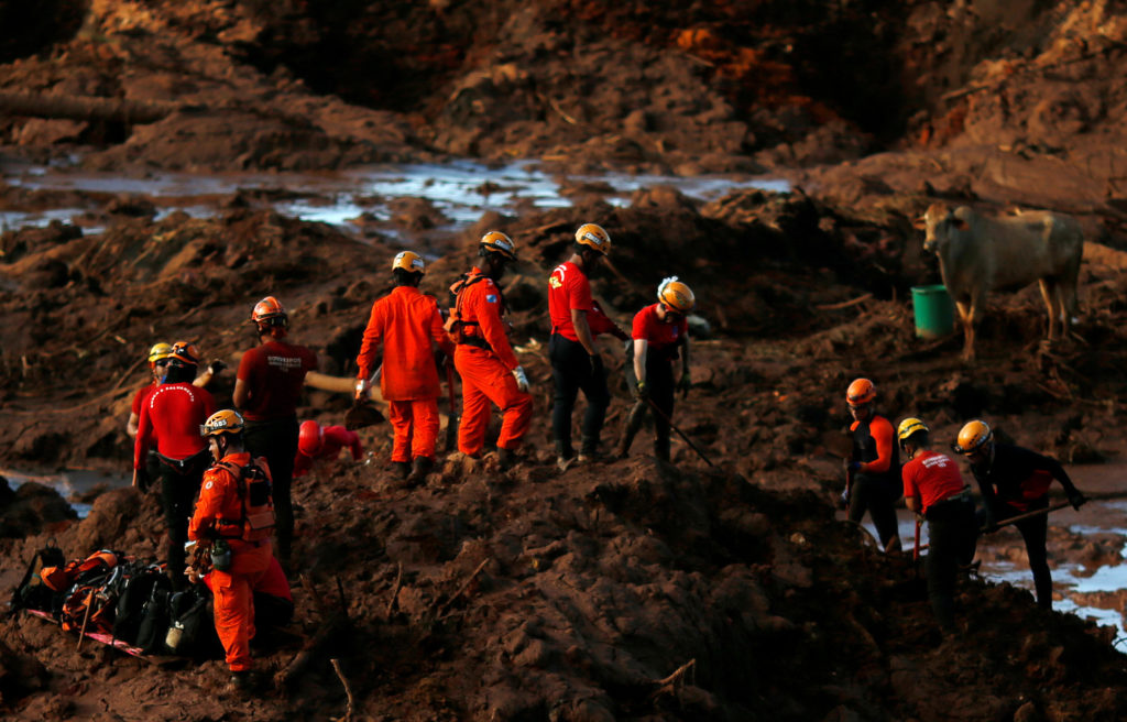 Members of a rescue team search for victims after a tailings dam owned by Brazilian mining company Vale SA collapsed, in B...