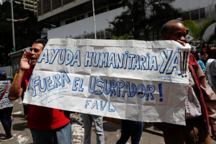 Supporters of Venezuelan opposition leader and self-proclaimed interim president Juan Guaido hold a banner reading "humanitarian aid now outside the usurper" during a protest against Venezuelan President Nicolas Maduro's government in Caracas, Venezuela January 30, 2019. Photo by Carlos Garcia Rawlins/Reuters