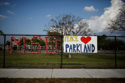 The initials of Marjory Stoneman Douglas High School and a placard are placed on the fence at Park Trails Elementary School, following a mass shooting in Parkland, Florida. Photo by Carlos Garcia Rawlin/Reuters