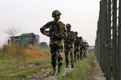 India's Border Security Force (BSF) soldiers patrol along the fenced border with Pakistan in Ranbir Singh Pura sector near Jammu. Photo by Mukesh Gupta/Reuters