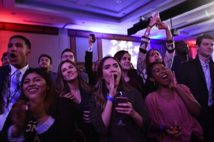 People cheer while watching election results during a midterm election night party hosted by the Democratic Congressional Campaign Committee November 6, 2018 in Washington, DC. (Photo by Brendan Smialowski / AFP) (Photo credit should read BRENDAN SMIALOWSKI/AFP/Getty Images)