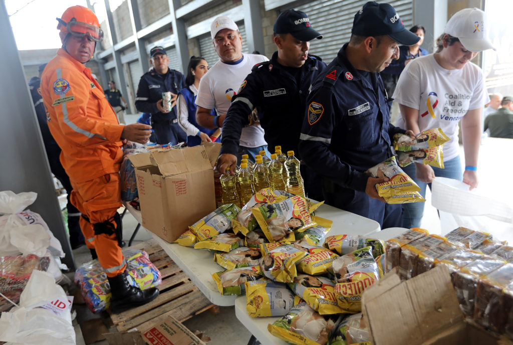 People organize humanitarian aid for Venezuela at a warehouse near the Tienditas cross-border bridge between Colombia and ...