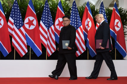 FILE PHOTO: U.S. President Donald Trump and North Korea's leader Kim Jong Un walk during their summit at the Capella Hotel on Sentosa island in Singapore June 12, 2018. Anthony Wallace/Pool via Reuters
