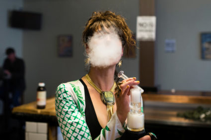 Elise McRoberts exhales after using a full spectrum oil vaporizer at the new Magnolia cannabis vape lounge in Oakland, California, U.S. April 20, 2018. Photo by REUTERS/Elijah Nouvelage