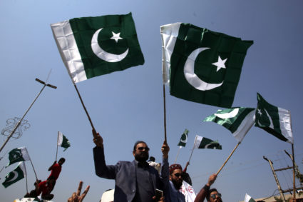 People carry national flags as they celebrate, after Pakistan shot down two Indian military aircrafts, in Lahore, Pakistan February 27, 2019. Photo by REUTERS/Mohsin Raza