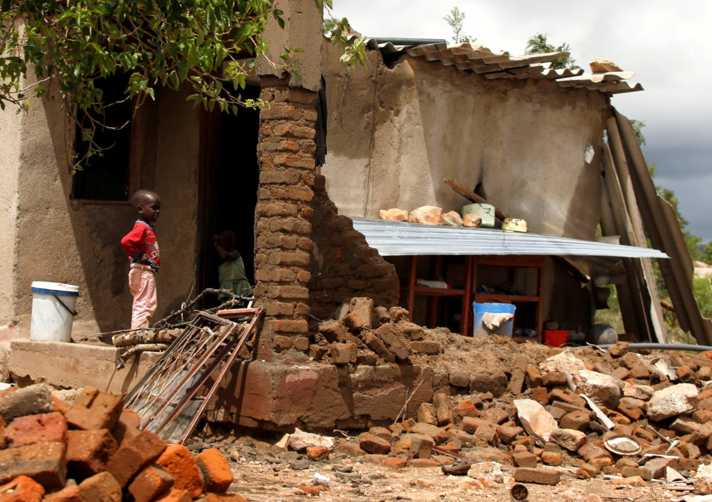 A boy looks on at a family home destroyed by floods following Cyclone Idai in Chimanimani district, Zimbabwe, on March 18,...