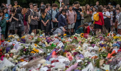 Schoolchildren and other well-wishers view flowers and tributes near Al Noor mosque on March 18, 2019 in Christchurch, New Zealand. Photo by Carl Court/Getty Images