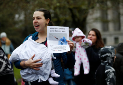Jessica Castro of Federal Way, Washington, holds up a sign against SB 5841 while holding her 2-month-old baby Zoe during the "March for Medical Freedom" against mandatory vaccinations before the SB 5841 hearing in Olympia, Washington, U.S., February 20, 2019. Photo by REUTERS/Lindsey Wasson