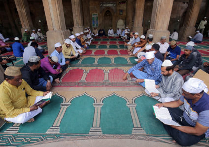 Muslims read the Koran during a prayer meet for victims of Friday's mosque attacks in New Zealand, inside a mosque in Ahmedabad, India, March 16, 2019. REUTERS/Amit Dave - RC12E8652BF0