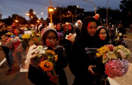 People react as they move the flowers after police removed a police line, outside Masjid Al Noor in Christchurch, New Zealand, March 16, 2019. Photo by Jorge Silva/Reuters