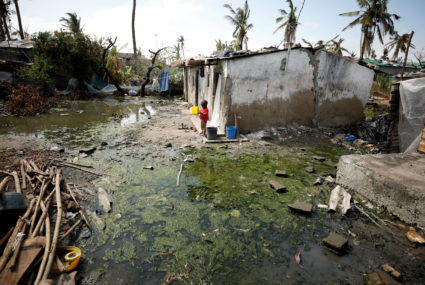 A child stands amongst pools of stagnant water in Beira, Mozambique on March 27, 2019. Health workers say every day they are seeing up to 200 likely cases of cholera, which can be spread through contaminated food or water. Photo by Mike Hutchings/Reuters