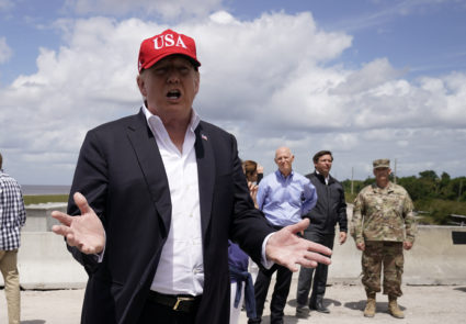 President Donald Trump speaks to reporters as U.S. Senator Rick Scott, Florida Governor Ron Desantis and others look on during the president's visit to Lake Okechobee and the Herbert Hoover Dike in Canal Point, Florida, on March 29, 2019. Photo by Joshua Roberts/Reuters